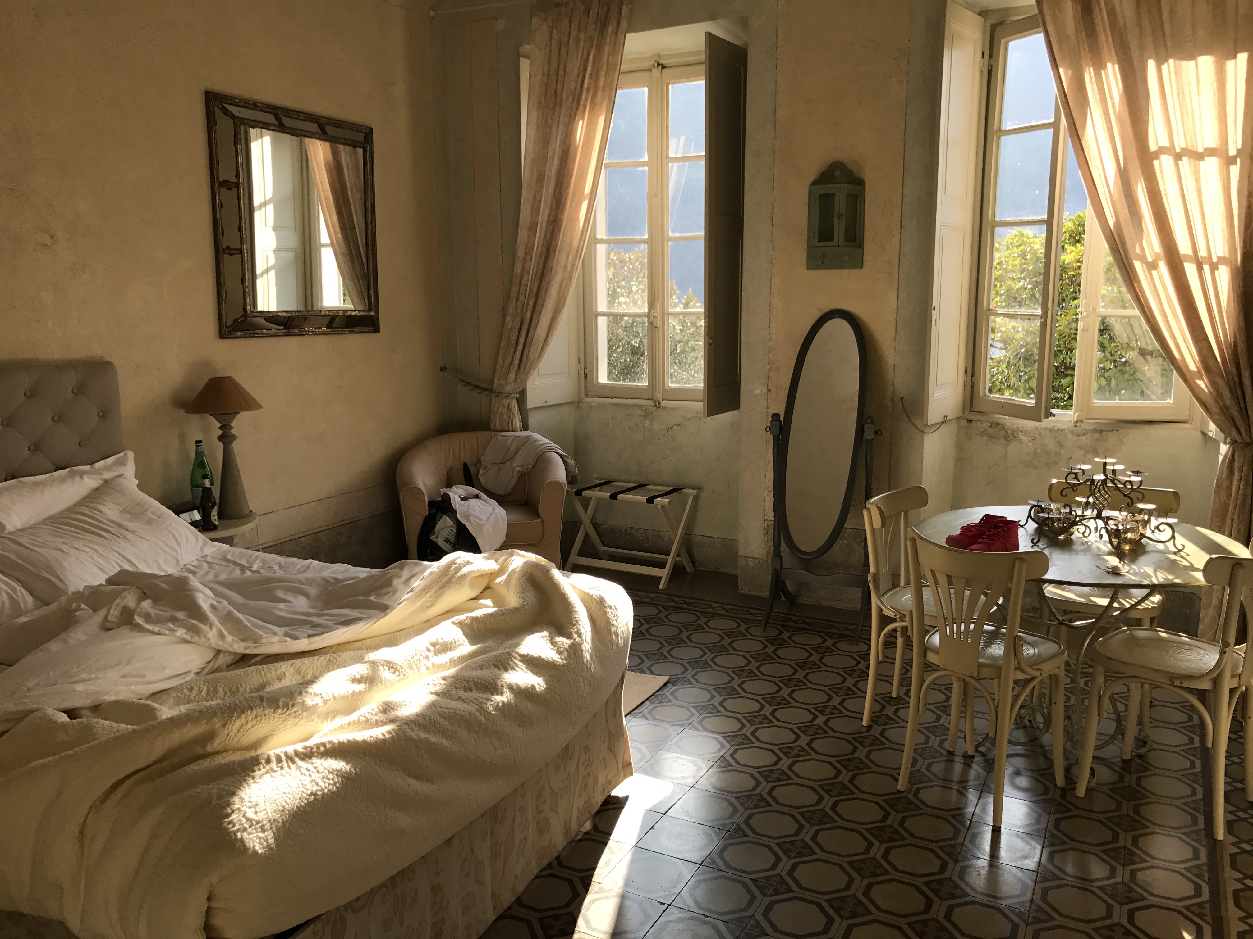 Softly lit interior room with pale walls and sun through the windows.